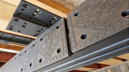 Aufkleber - Closeup of the mounting plates that will attach the rail supports to the ceiling framework showing the intricate etched patterns and bolt hole arrangements that facilitate rapid