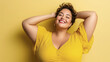 © OHMAl2T - Happy Plus-Sized Latina Woman Smiling with Short Hair on Yellow Background