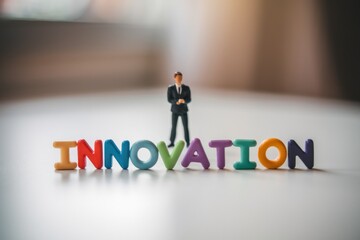 Poster - A miniature businessman stands before the word 'Innovation', symbolizing progress and new ideas.