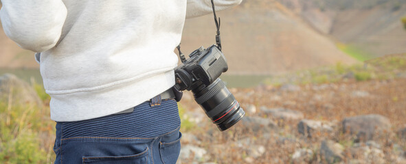 Photographer with a professional camera in nature.