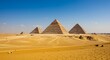 The pyramids of Giza rising majestically in the golden sands of the Egyptian desert under a clear sky.