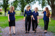 © Austockphoto - team of happy smiling businesswomen in group talking together outdoors
