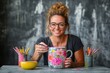 © Евгения Рубцова - Woman enjoys decorating a ceramic mug with bright flowers in artistic studio