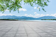 © ABCDstock - Empty square floor and lake with mountain nature landscape in summer. Outdoor natural background.
