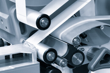 Poster - Fragment of the conveyor of sticking labeling machine. Abstract industrial background.