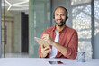 © Liubomir - Webcam view, a man with a headset and a notepad in his hands looks into the camera, records data while listening to an online meeting and conference with colleagues and partners.