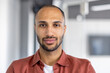 © Liubomir - Close-up portrait of a man looking at the camera, serious and confident. Businessman at workplace inside office, office worker in casual shirt.