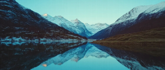 Poster - Majestic snow-covered mountains reflecting in a tranquil fjord at dawn