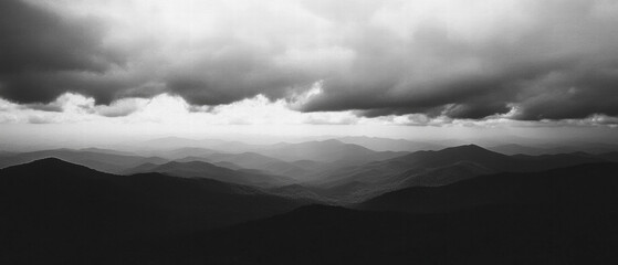 Poster - Dramatic cloudy sky over imposing mountains creates a moody atmosphere at dusk
