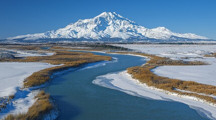 Wall Mural - Panoramic view of snow-capped mountain, river, and winter landscape.