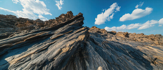 Poster - Lava flow cooling into unique rock formations under a bright blue sky