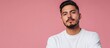 © The 2R Artificiality - Confident young Hispanic man with a relaxed yet focused expression, casually posed against a vibrant pink background, looking directly into the camera, portrait, fashion, lifestyle.