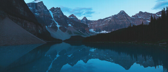 Poster - Mountain lake reflecting serene peaks in a tranquil twilight setting