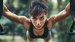 © The 2R Artificiality - Fit woman with short hair performing push ups using TRX fitness straps in an outdoor park setting under natural daylight showcasing athletic physique and strength