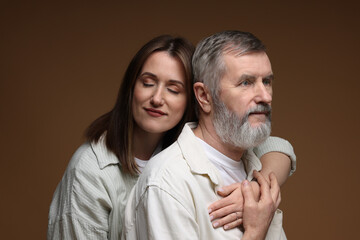 Wall Mural - Daughter and her father on brown background