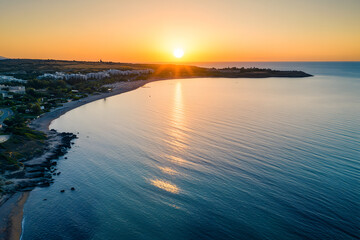 Beautiful sunset over the sea with an orange sky and sun, a summer landscape