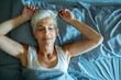 © Marko Geber - Senior woman relaxing in bed with peaceful expression