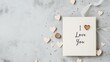 © Yuliia - A handmade Valentine's Day card with the phrase 'I Love You' written in elegant calligraphy, surrounded by small watercolor hearts