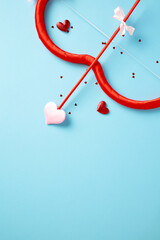 Wall Mural - St Valentines Day concept with cupid bow and arrow on blue background