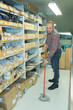 © auremar - a man moping warehouse floor