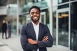 © Baba Images - Smiling portrait of a young African American businessman in modern office