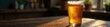 © retirementfun - Condensation-covered glass of beer sits on dark wood table , alcohol, brown