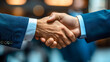 © mahamad - Close-up of successful businesspeople shaking hands.