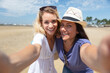 © auremar - two women on a beach take a selfie