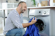 © auremar - man doing laundry at home