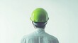 © Kullanat - Worker in Green Hard Hat Against Minimal Background