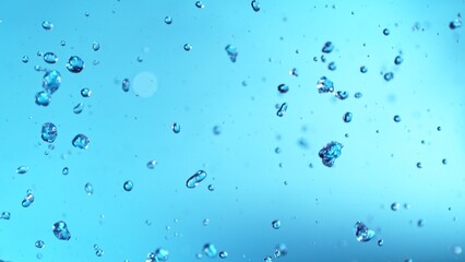 Poster - Abstract Splash of Water on a Blue Background. Drops Isolated Flying in the Air.