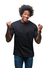 Wall Mural - afro american man over isolated background very happy and excited doing winner gesture with arms rai