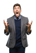 © Krakenimages.com - Young handsome business man over isolated background crazy and mad shouting and yelling with aggressive expression and arms raised. Frustration concept.