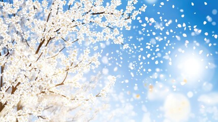 Wall Mural - A serene scene of a flowering tree against a bright blue sky with floating petals.