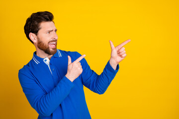 Poster - Photo portrait of attractive young man point empty space dressed stylish blue clothes isolated on yellow color background