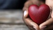 © Albert - A person holding a red heart in their hands
