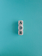 Wall Mural - ADM Alternative Dispute Resolution symbol. Wooden cubes with word ADM on beautiful blue background. Business concept.