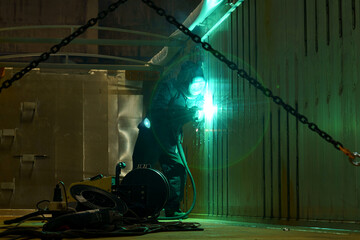 Poster - Bright sparks illuminate the workshop during late-night metalwork session
