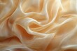 © dyageleva - Smooth gold silk fabric flowing and creating soft folds, ideal for backgrounds and designs related to luxury, fashion, and elegance
