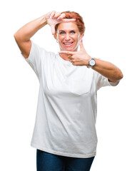 Wall Mural - Atrractive senior caucasian redhead woman over isolated background smiling making frame with hands and fingers with happy face. Creativity and photography concept.