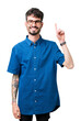 © Krakenimages.com - Young handsome man wearing glasses over isolated background showing and pointing up with finger number one while smiling confident and happy.