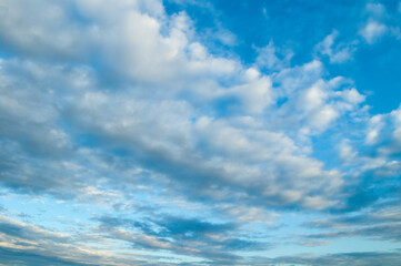 Wall Mural - dramatic stormy sky landscape with colorful fluffy clouds, sweeping blue cloudy sky background