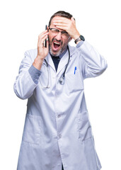 Wall Mural - Middle age senior hoary doctor man talking on smartphone over isolated background stressed with hand on head, shocked with shame and surprise face, angry and frustrated. Fear and upset for mistake.