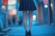 © Alla - A person wearing a skirt and high heels walking on a busy city street, great for lifestyle or fashion images