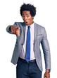 © Krakenimages.com - Handsome african american man with afro hair wearing business jacket pointing displeased and frustrated to the camera, angry and furious with you