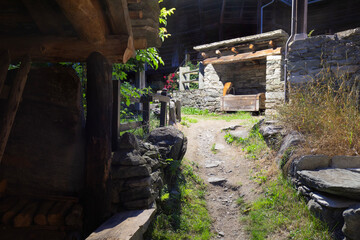 Wall Mural - The rural architecture of Alagna village (little well) in the Valsesia valley range at night - Italy.