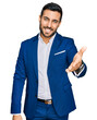 © Krakenimages.com - Young hispanic man wearing business jacket smiling friendly offering handshake as greeting and welcoming. successful business.