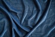 © Yaroslav - Textured blue fabric draped elegantly with soft creases in natural light highlighting the weave and color variations
