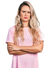 Wall Mural - Young blonde woman with arms crossed gesture skeptic and nervous, frowning upset because of problem. negative person.