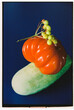 © Natalia Mishina/Stocksy - Fresh tomatoes and cucumber displayed on a blue background.